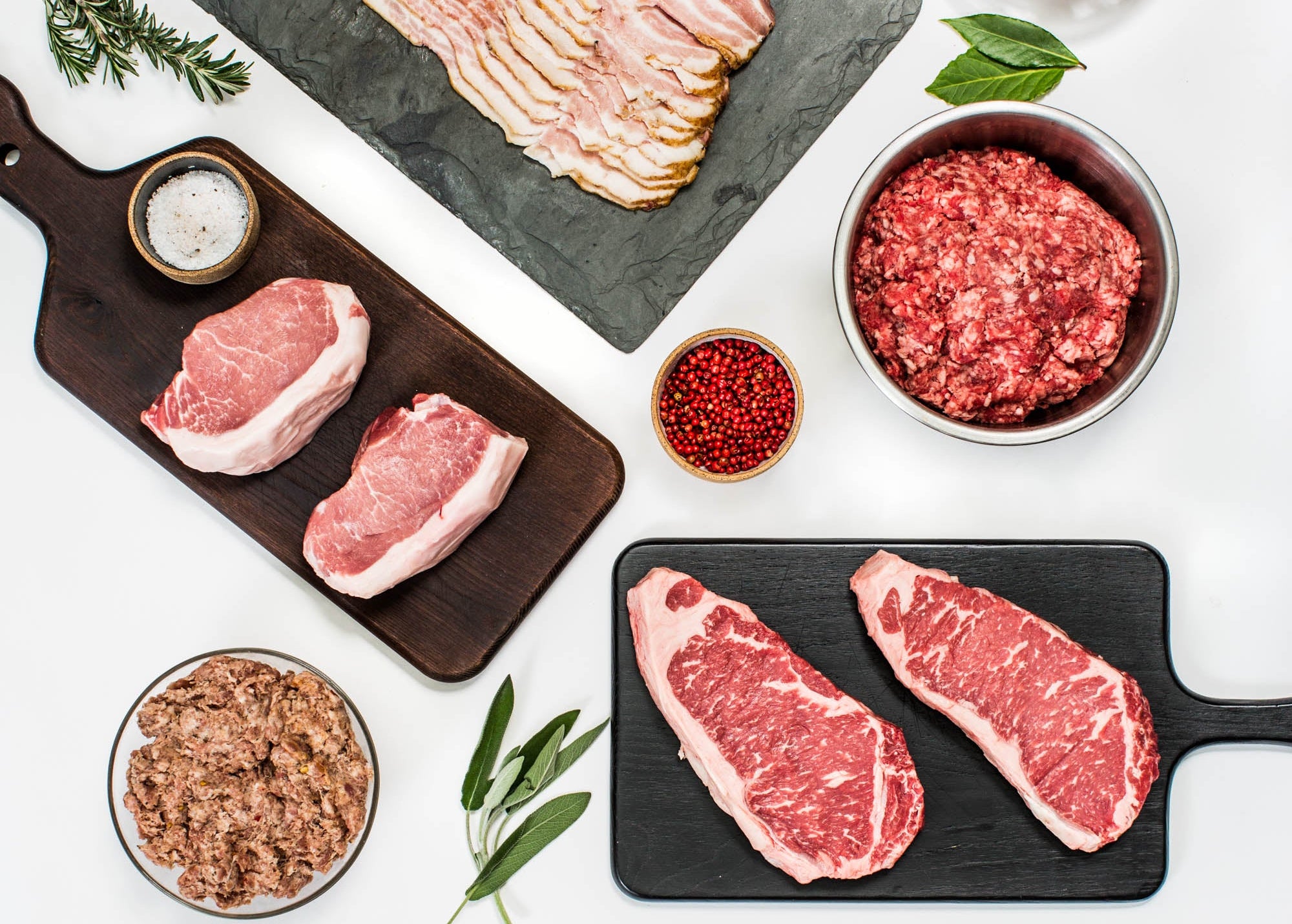 meat and bacon and sausage on cutting boards